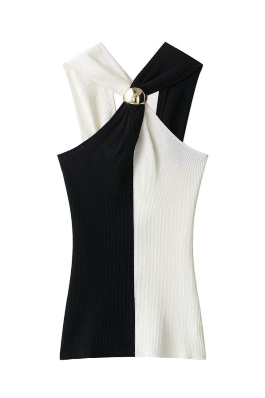 A sleek and modern design in timeless black and white contrast. This top features a ribbed knit fabric that flatters the silhouette, with a unique twisted neckline held together by a chic gold detail.

Perfect to pair with high-waisted trousers or midi skirts, this piece is ideal for dinners, cocktails, or night outs with a refined yet bold touch.

